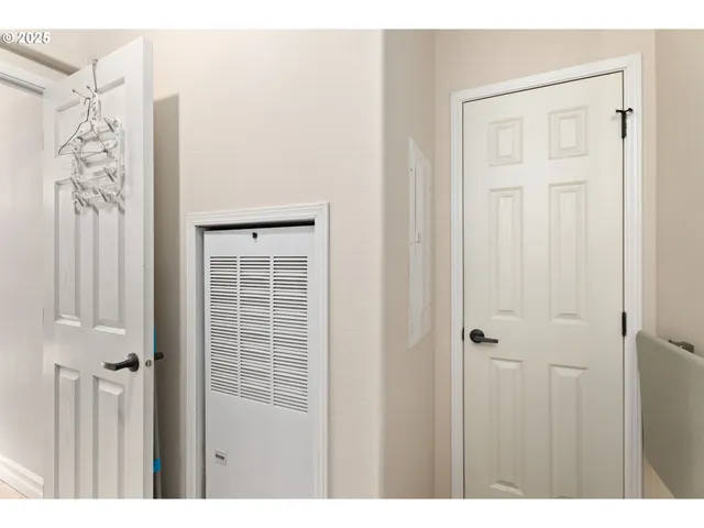 a view of a house with a wooden bench in a yard