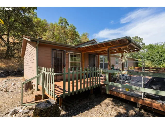 a backyard of a house with table and chairs