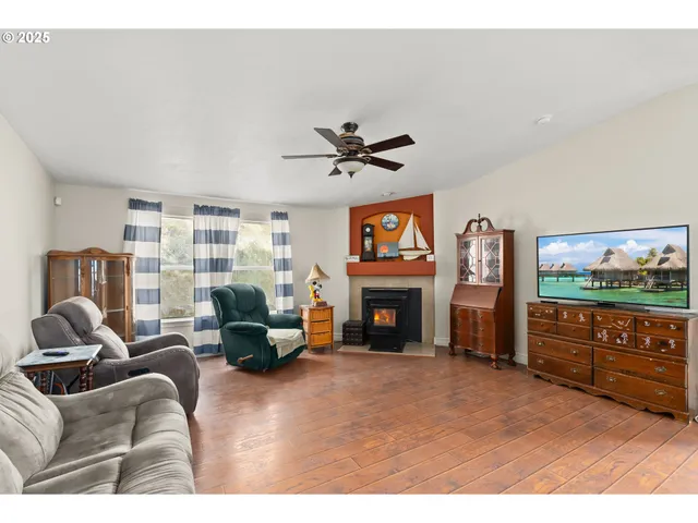 a living room with furniture a window and stainless steel appliances