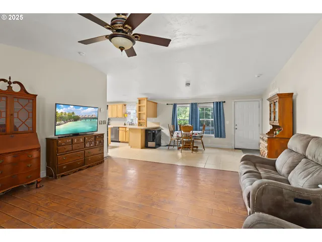 a dining room with furniture and a floor to ceiling window