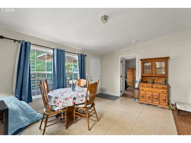 a kitchen with stainless steel appliances granite countertop a sink a stove a refrigerator a microwave oven with white cabinets and wooden floor