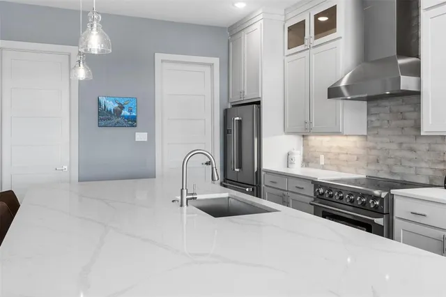 a kitchen with stainless steel appliances a sink stove and cabinets