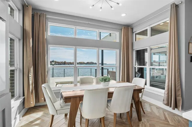 a dining room with furniture window and wooden floor