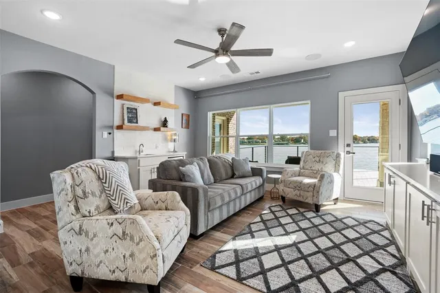 a living room with furniture and a large window with outer view