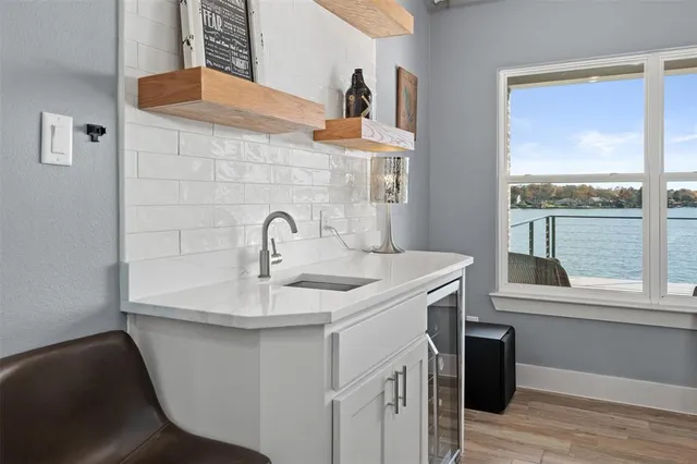 a kitchen with a sink cabinets and a large window