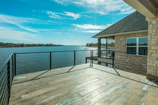 a view of a terrace with wooden floor and fence