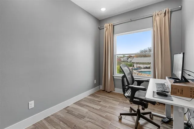 a view of a workspace with furniture and a window