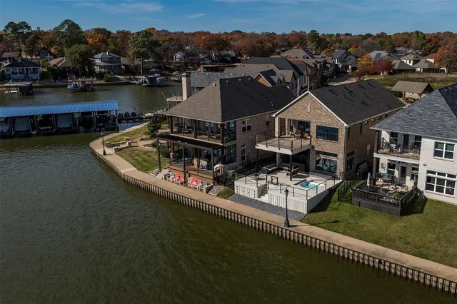 an aerial view of a house with a garden and lake view
