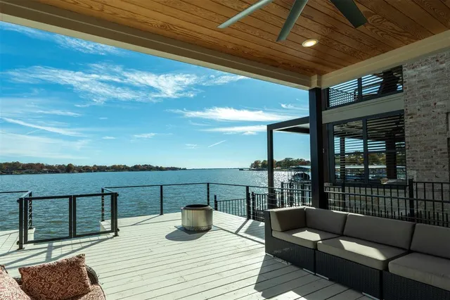 a view of roof deck with couches and ocean view