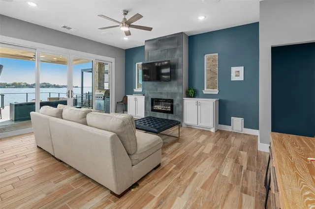a living room with furniture a flat screen tv and a fireplace
