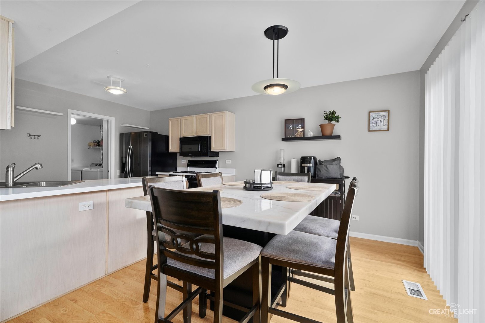 1369 Spaulding Road Bartlett, IL 60103 - Photo 4 of 15 a kitchen with a dining table chairs and refrigerator