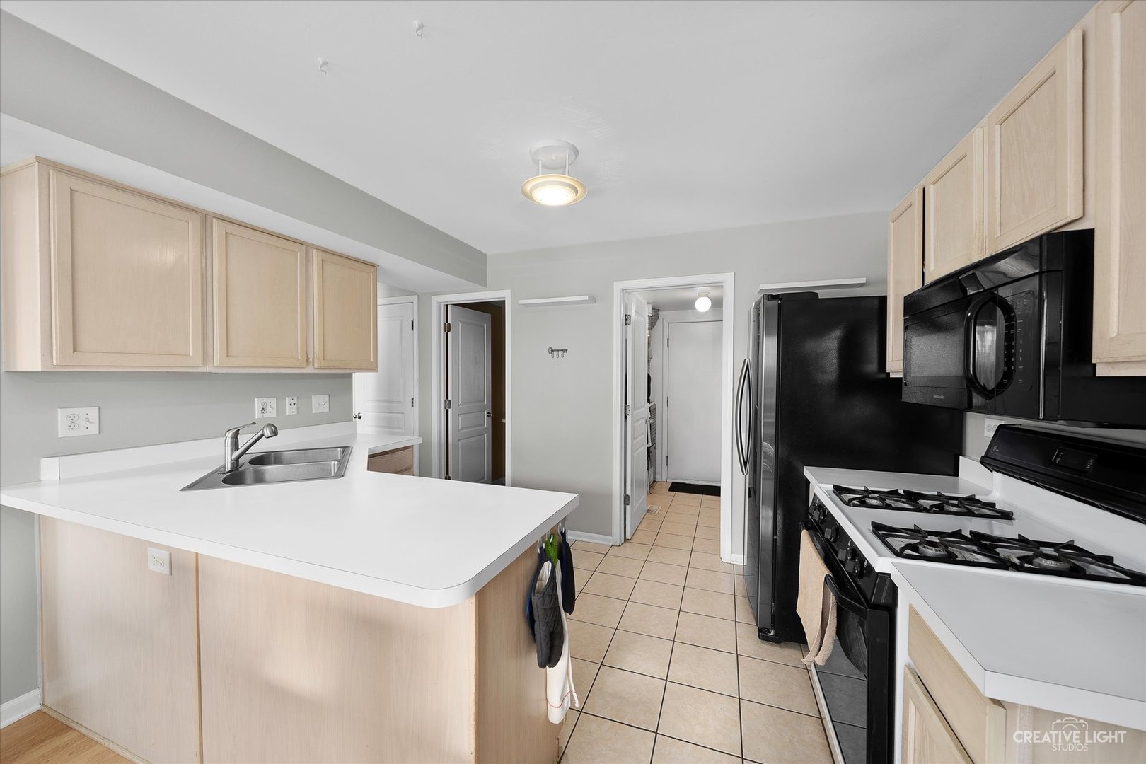 1369 Spaulding Road Bartlett, IL 60103 - Photo 5 of 15 a kitchen with stainless steel appliances a stove a sink and a refrigerator