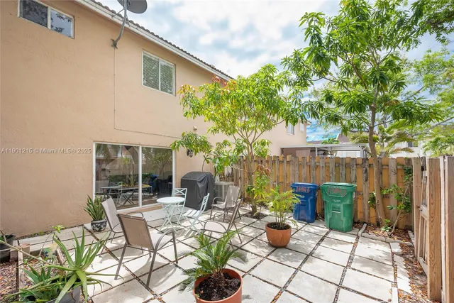 a view of a patio with couches and potted plants