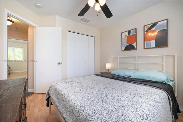 a bedroom with a bed and painting on the wall