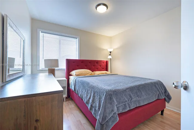 a bedroom with a bed and a night stand