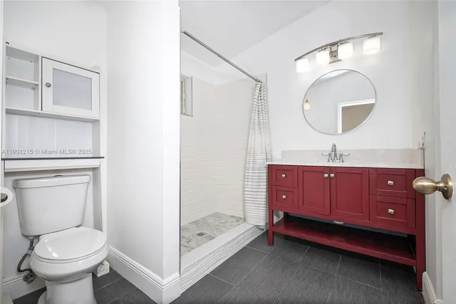 a bathroom with a toilet sink and mirror