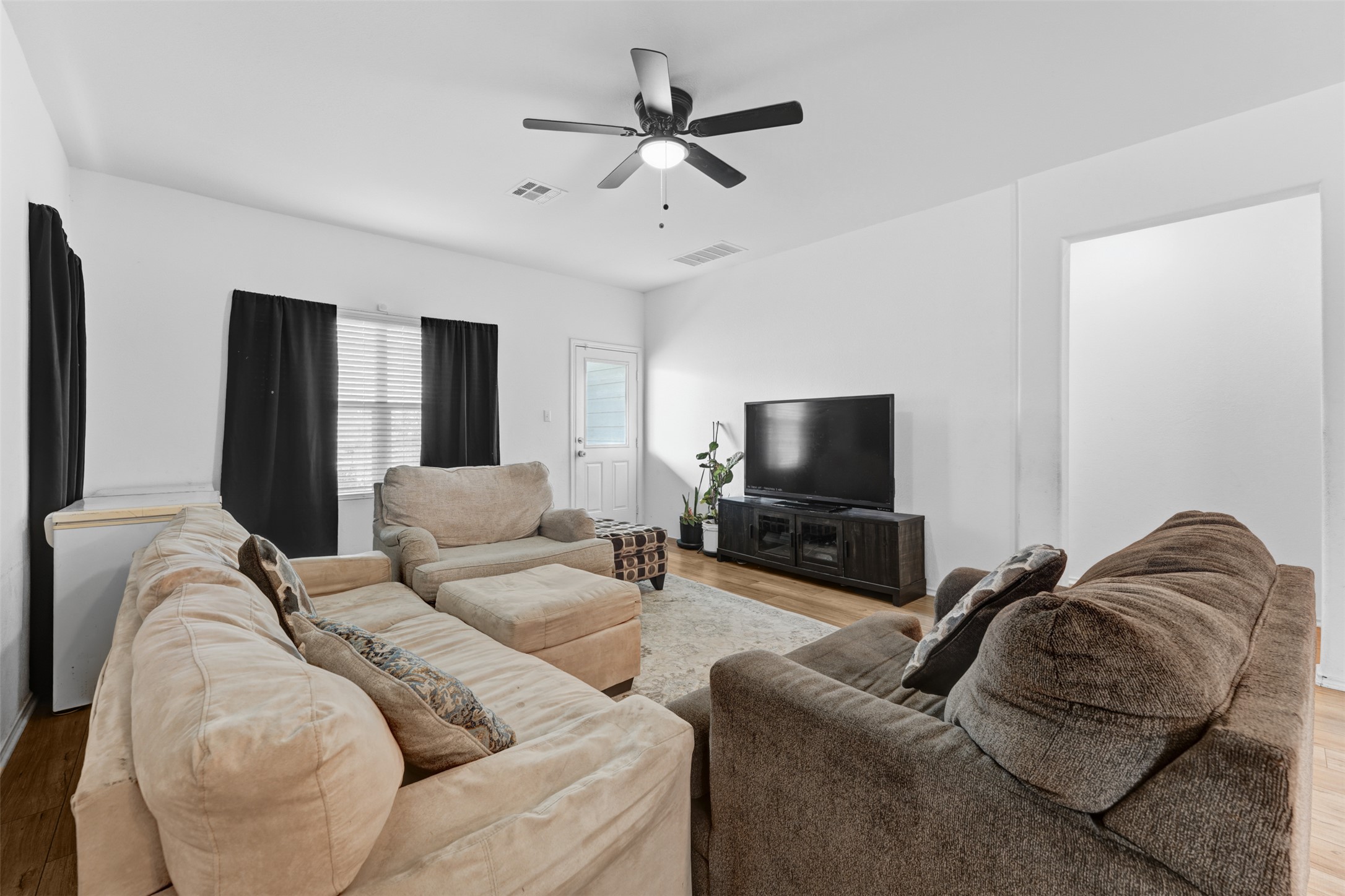 413 Perfect World Loop Jarrell, TX 76537 - Photo 13 of 39 Relax in this inviting living room featuring durable hardwood flooring and a refreshing ceiling fan.