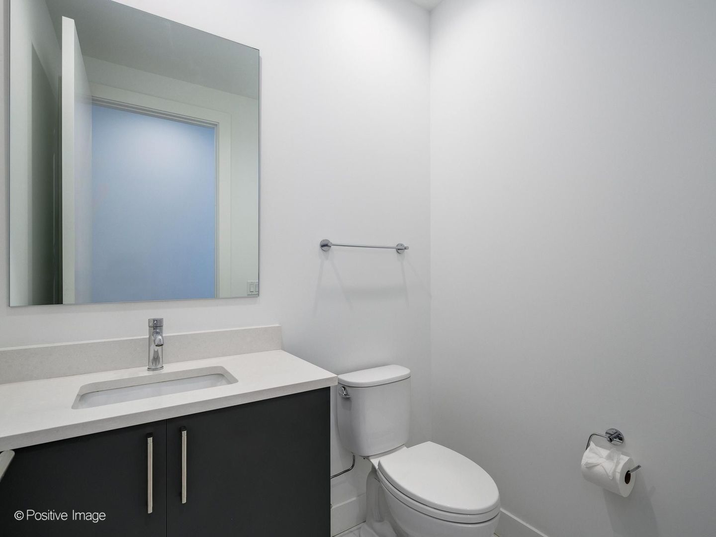 305 South Racine Avenue, Unit 2A Chicago, IL 60607 - Photo 24 of 29 a bathroom with a sink a toilet and mirror