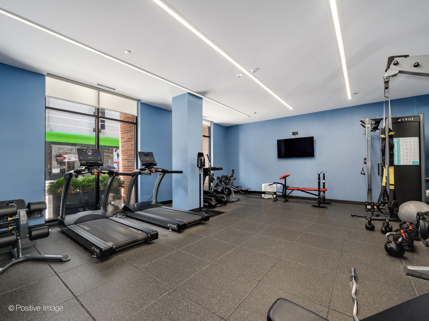 305 South Racine Avenue, Unit 2A Chicago, IL 60607 - Photo 27 of 29 a room with gym equipment and a large window