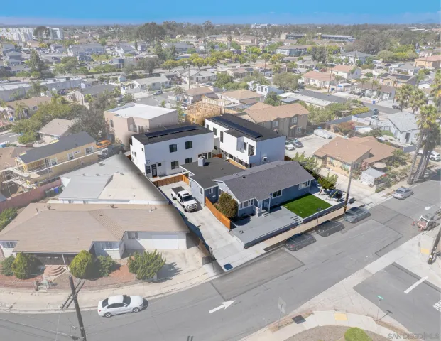 an aerial view of multiple houses with yard