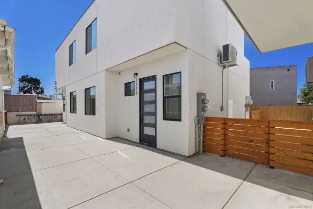 a large white kitchen with stainless steel appliances granite countertop a stove a sink and a refrigerator