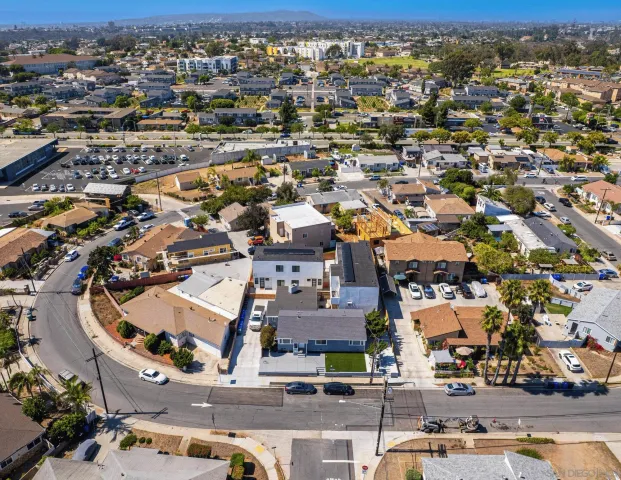 an aerial view of residential houses with yard