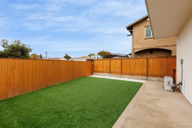 a front view of a house with a yard and a garage