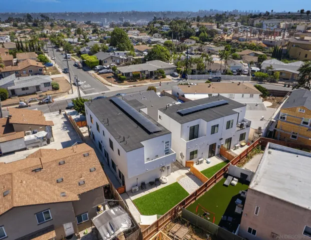 a view of house with yard street and ocean view