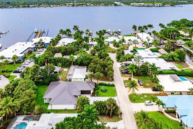 an aerial view of a house with a yard and lake view