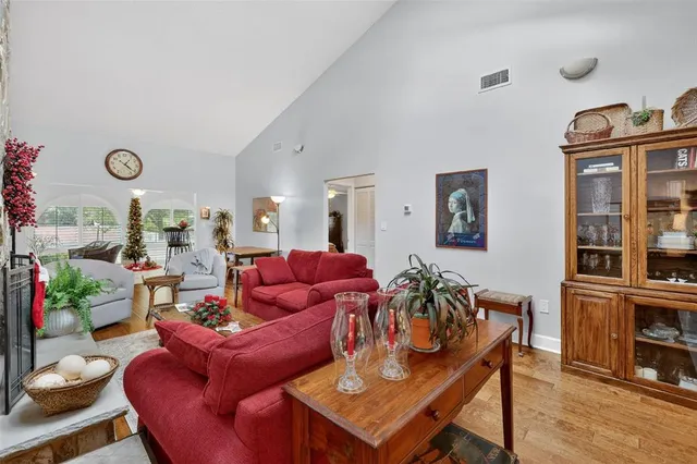 a living room with furniture kitchen view and a window