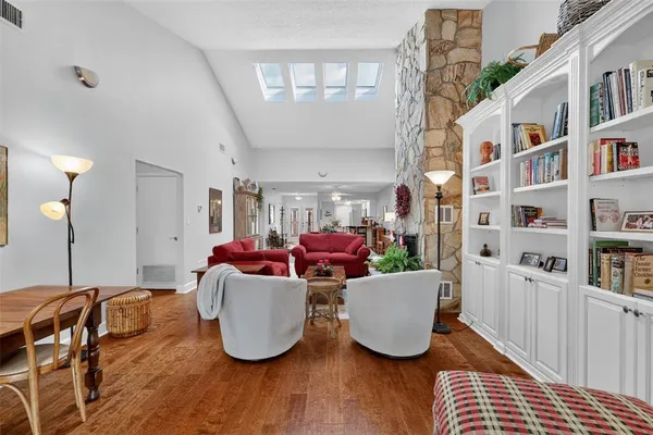 a living room with furniture and a book shelf