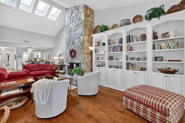 a living room with furniture and a book shelf