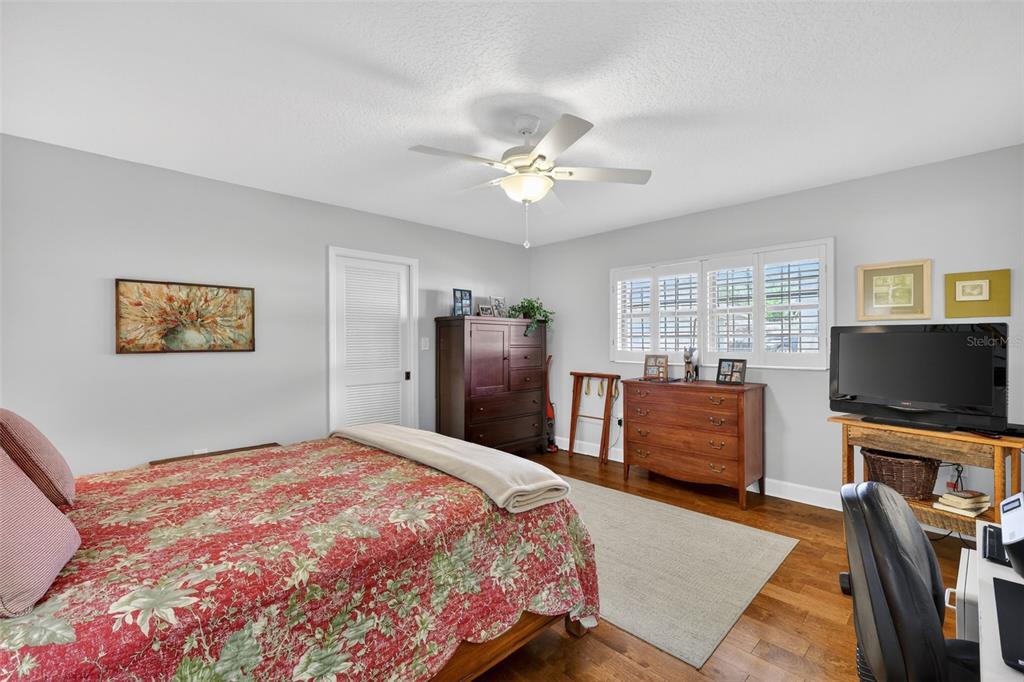 100 South Tremain Street, Unit F1 Mount Dora, FL 32757 - Photo 18 of 47 a bedroom with a bed and a flat screen tv