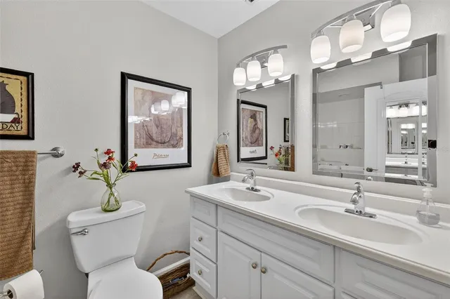 a bathroom with double sink and a toilet