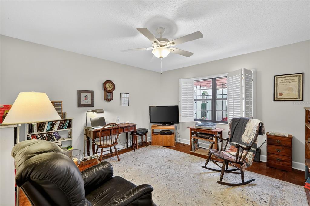 100 South Tremain Street, Unit F1 Mount Dora, FL 32757 - Photo 23 of 47 a living room with furniture and a flat screen tv with wooden floor