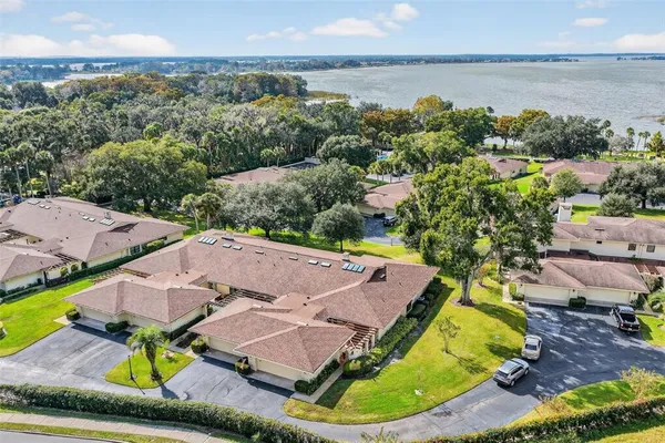 an aerial view of a house with swimming pool and lake view