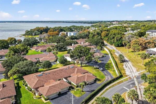 an aerial view of residential houses with outdoor space and swimming pool