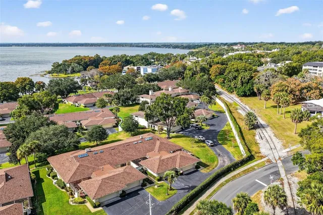 an aerial view of residential houses with outdoor space and swimming pool