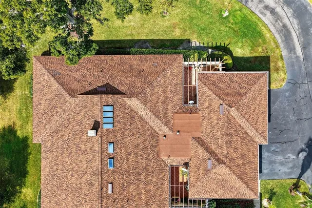 aerial view of a house with a yard