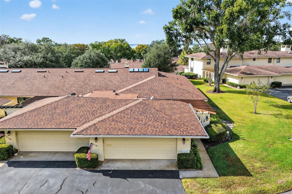 100 South Tremain Street, Unit F1 Mount Dora, FL 32757 - Photo 31 of 47 an aerial view of a house with swimming pool and large trees