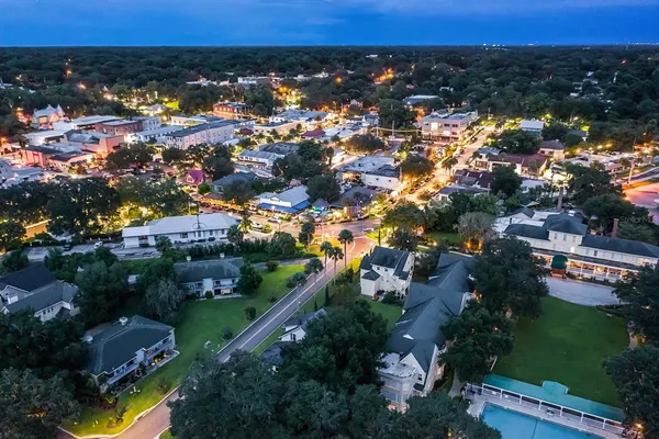 a view of a store with palm trees
