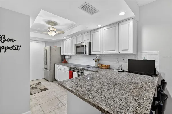 a kitchen with a stove a refrigerator and a sink