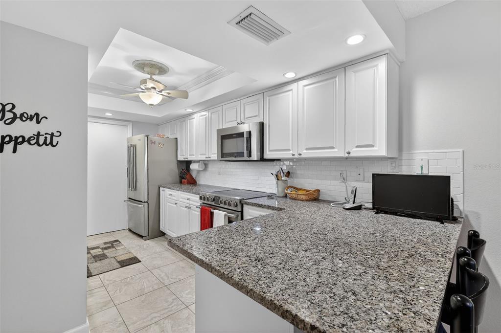 100 South Tremain Street, Unit F1 Mount Dora, FL 32757 - Photo 5 of 47 a kitchen with a stove a refrigerator and a sink