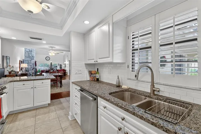 a kitchen with granite countertop a sink and cabinets