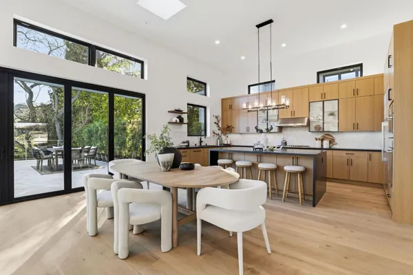 a view of a dining room with furniture large windows and wooden floor