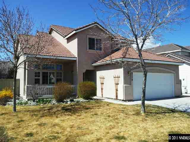 9779 Thunder Mountain Way Reno, NV 89521 - Photo 1 of 12 a front view of a house with garden