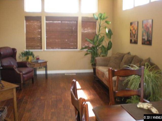 9779 Thunder Mountain Way Reno, NV 89521 - Photo 3 of 12 a living room with furniture and a potted plant