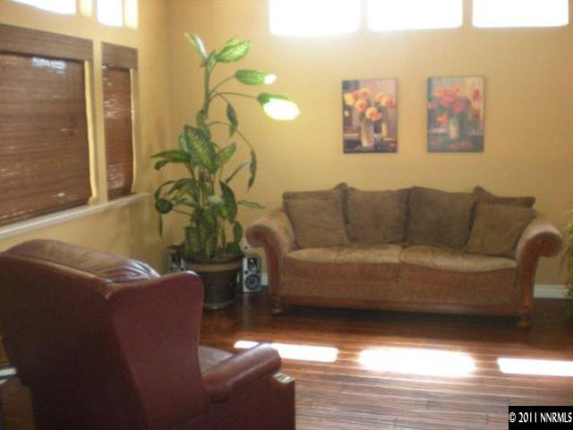 9779 Thunder Mountain Way Reno, NV 89521 - Photo 6 of 12 a living room with furniture a chandelier and a window