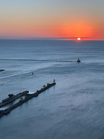 a room with lots of white furniture and a rug