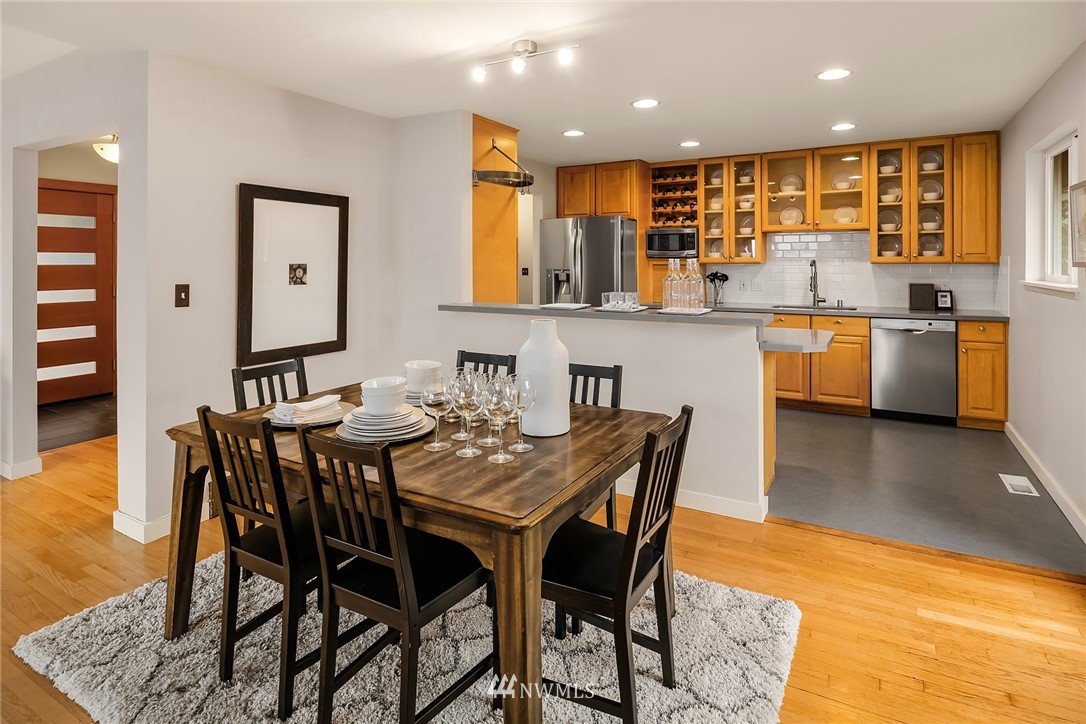 8750 Fauntlee Crest Southwest Seattle, WA 98136 - Photo 12 of 40 a kitchen with a table and chairs in it